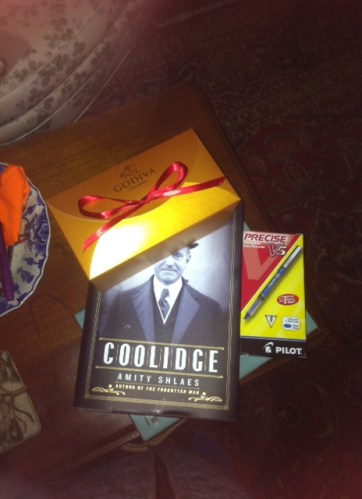 Godiva chocolates, a book and Pilot pens (blue)